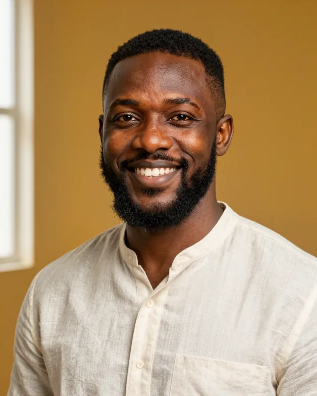 Portrait of Idris, a man in his early forties with a neat full beard